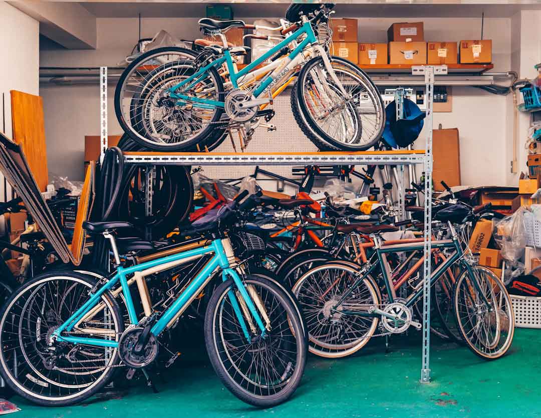 Used bicycle frames stacked in a warehouse