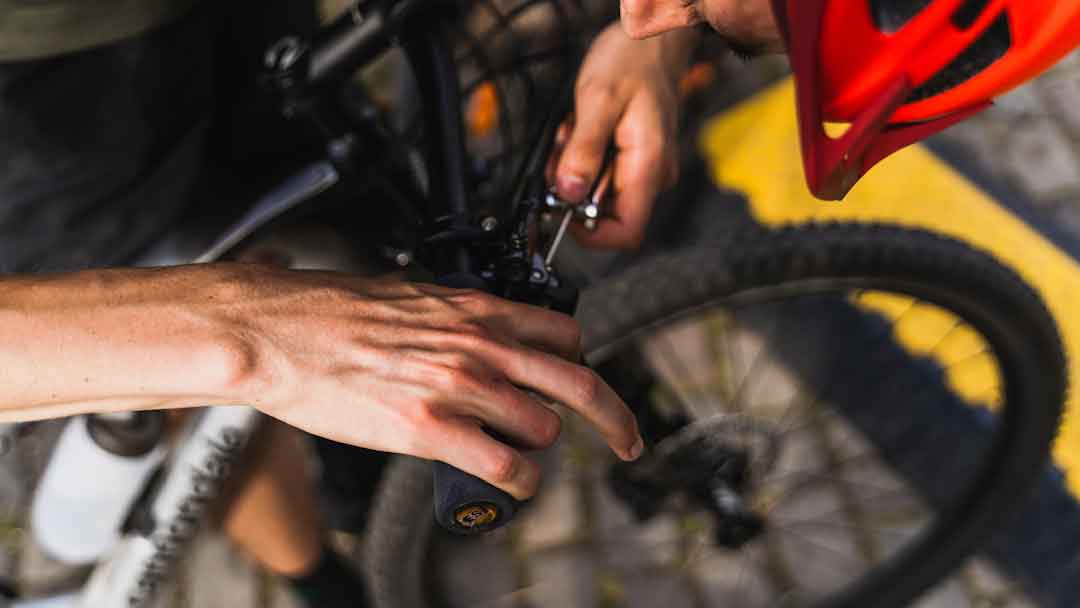 Hand inspecting a bicycle brake