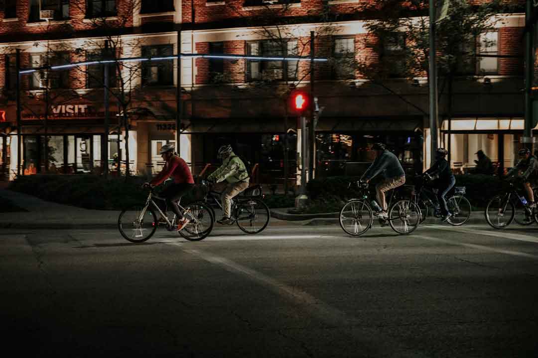 Group of cyclists riding budget road bikes on a city street