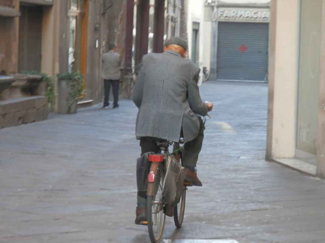 A cyclist adjusting the saddle of a road bike