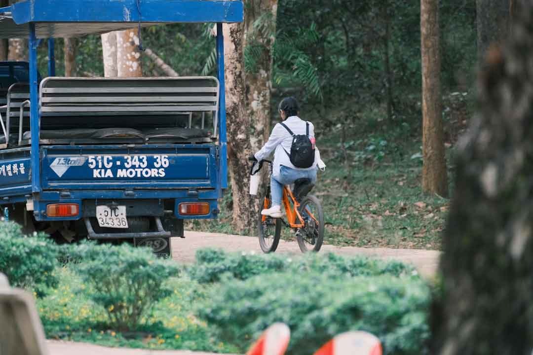 Cyclist performing maintenance on a road bike