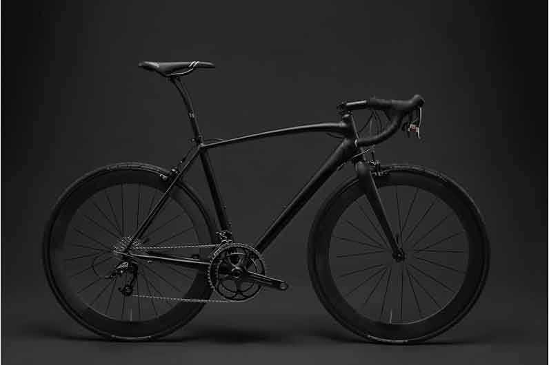 An elegant titanium gravel bicycle frame with a unique brushed metal finish and seamless welding.