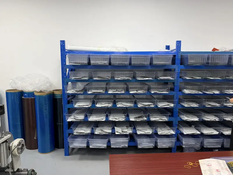 Carbon fiber prepreg rolls and layup material bins in the Mondince material store