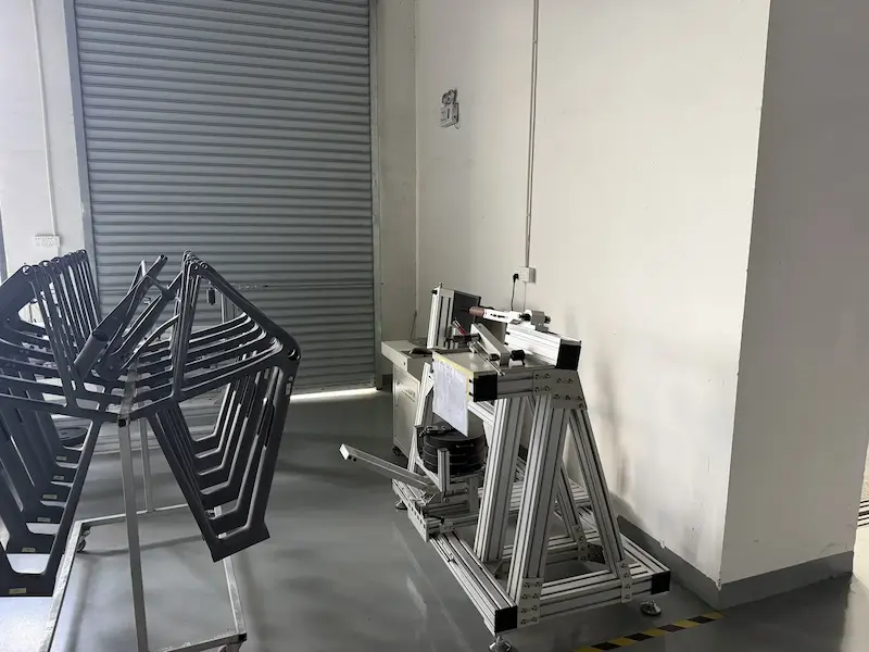 Carbon frames on a rack next to a bonding fixture