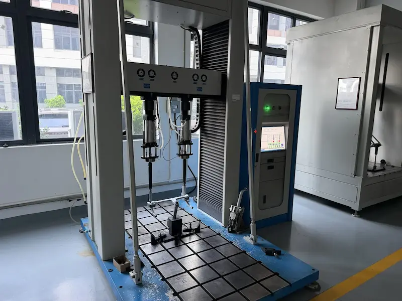 Large testing machine applying controlled loads to a carbon bike frame