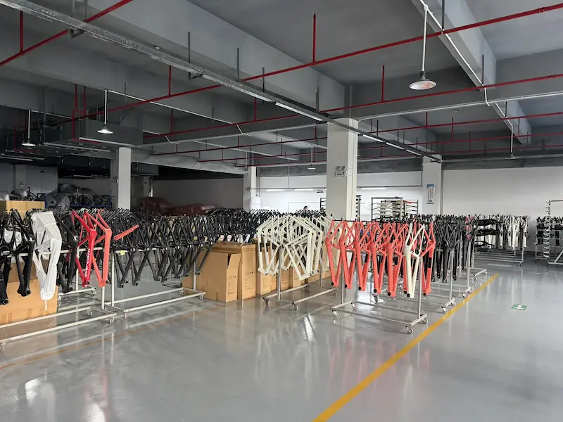 Production line of painted carbon bike frames in multiple colours