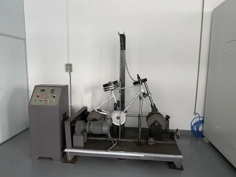 Road simulation drum rig with a carbon bike frame mounted
