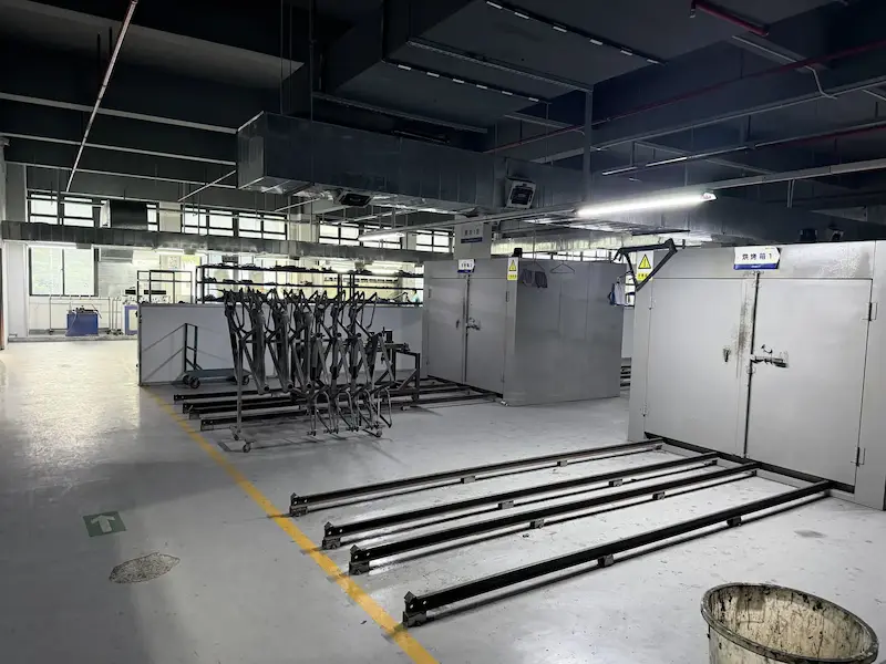 Carbon gravel frames staged in the paint and curing area of the Mondince factory